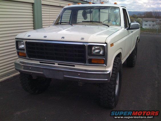 White Ford F-250 truck, front view, lifted with large tires