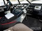 Custom off-road interior with multiple gauges, CB radio, and roll cage