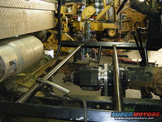 Vehicle chassis interior view showing transmission, transfer case, and exhaust system
