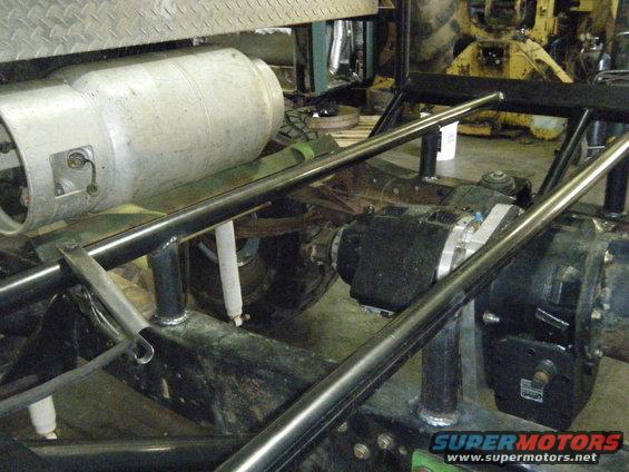 Vehicle underbody with large tank and drivetrain components visible