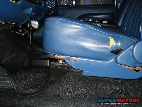 1995 Ford Bronco interior showing torn blue driver's seat and floor mat