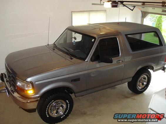 Silver two-door Ford Bronco parked in a garage