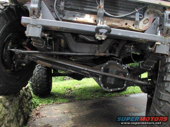 Undercarriage view of a lifted 4x4 with large tires and heavy-duty suspension components