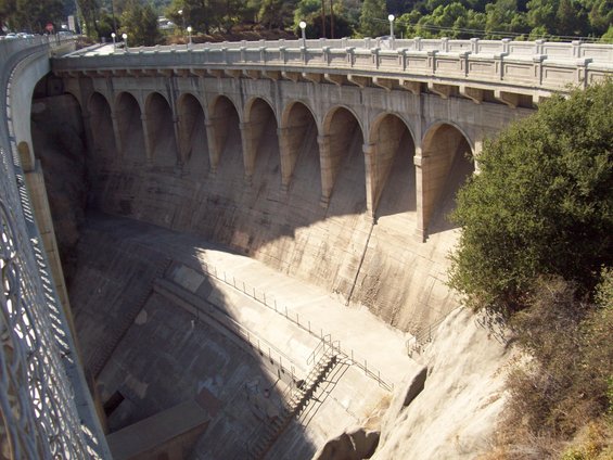 Concrete dam with arched spillway and a dry basin below