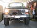 1985 Ford Bronco - Front view of a lifted Ford Bronco with aftermarket Bosch fog lights and a chrome grille.