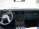 1985 Ford LTD - The interior of a 1985 Ford LTD shows a dashboard with wood grain accents and a prominent steering wheel.