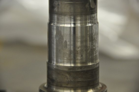 Close-up of a metal spindle with wear marks