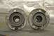 1996 Ford Bronco - Close-up view of two automotive spindle hubs, each containing roller bearings and showing signs of use.