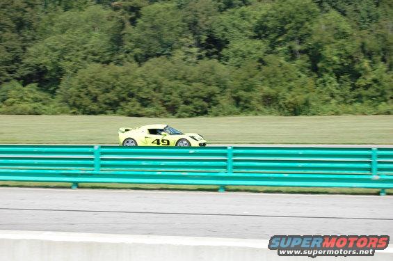 Yellow race car with number 49 on side, on track