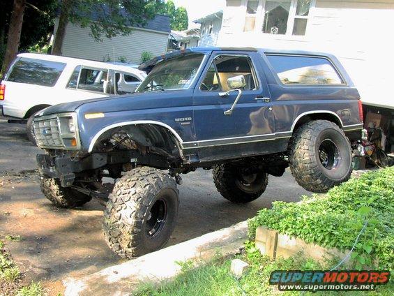 Blue lifted 1986 Ford Bronco with large off-road tires