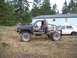 1985 Toyota Pickup/SR5 - This heavily modified pickup truck is missing its doors and body panels, sitting in a yard with a white car nearby.