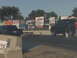 2005 Ford F-250 - Drag racing scene with two vehicles on the track and sponsor signs in the background.