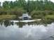 1993 Jeep Cherokee - A Jeep Cherokee navigates through a waterlogged trail surrounded by dense foliage and trees.