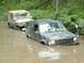 1993 Jeep Cherokee - Two Jeeps are stuck in muddy water during an off-road event.