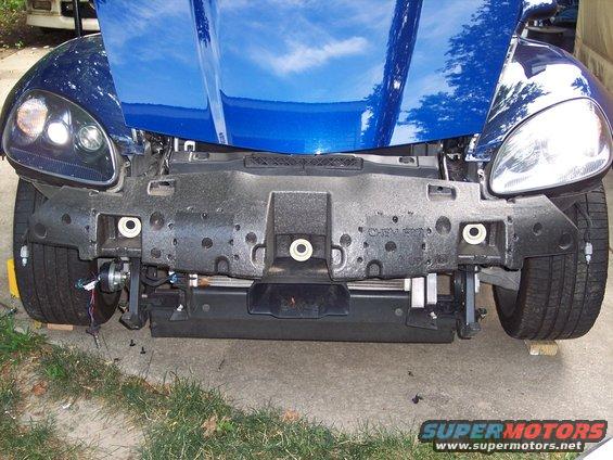 Blue car front bumper assembly removed, showing foam impact absorber and mounting points