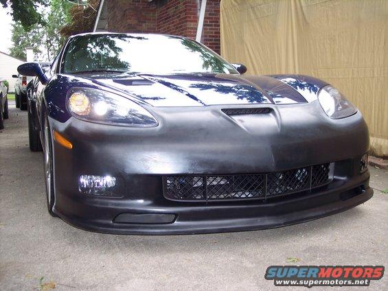 Dark blue Chevrolet Corvette C6 front bumper with black grille and fog lights