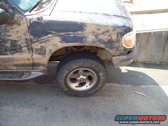 Mud-covered 1997 Mercury Mountaineer front passenger side, showing wheel and fender