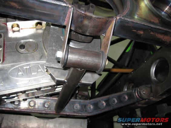Close-up of custom suspension parts, including an Atlas transfer case, with visible welds and bolts