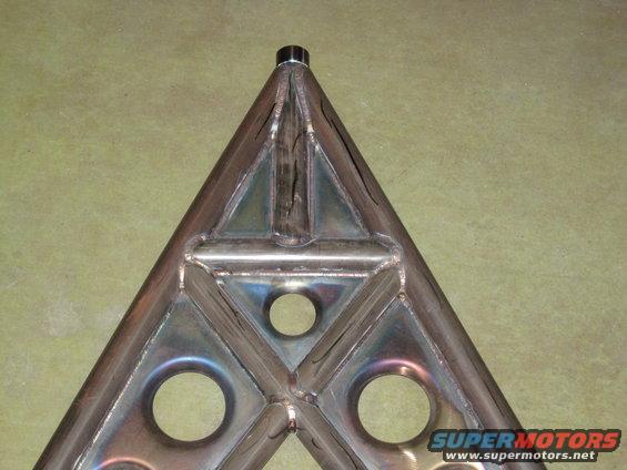 Custom fabricated triangular metal part with holes, Supermotors logo visible