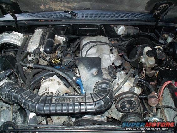 1994 Ford Ranger engine bay with V6 engine, air intake, alternator, and battery visible