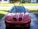 2001 Pontiac Trans Am - Front view of a red 2001 Pontiac Firebird parked on a wet driveway.