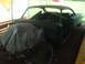 1960 Ford Starliner - A 1960 Ford Starliner car body is seen from a 3/4 front angle inside a garage.