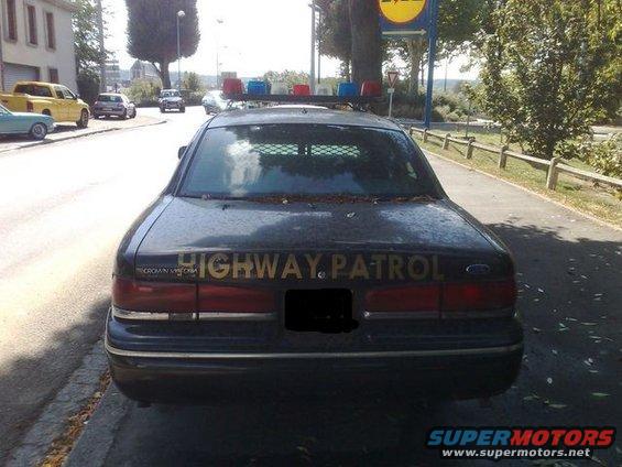 Rear view of black 1991 Ford Crown Victoria Highway Patrol car