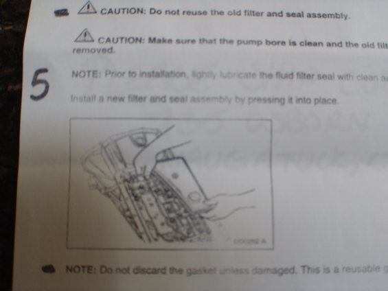 Diagram showing transmission filter installation with caution notes
