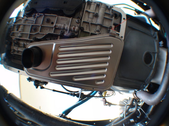 Transmission pan and filter assembly with a black intake tube