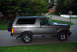 1995 Ford Bronco - A gray Ford Bronco is parked on the side of a road in a residential area.