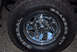 1995 Ford Bronco - Close-up of a chrome wheel with a General Grabber AT2 tire mounted.