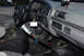 1995 Ford Bronco - The interior of a truck shows the dashboard, steering wheel, and aftermarket shifter.