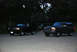 1995 Ford Bronco - Two Ford Broncos are seen parked in front of a house at dusk.