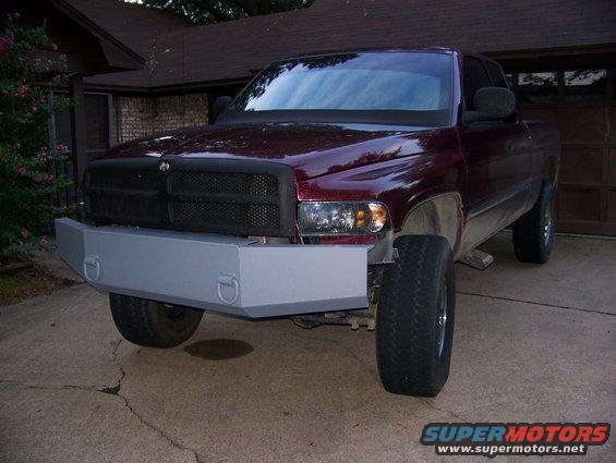 Maroon 2001 Dodge 1500 pickup truck with a gray aftermarket front bumper, parked in a driveway