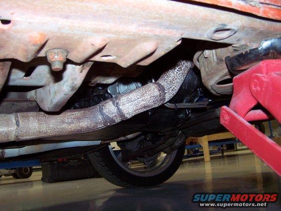 100_3053.jpg I re-used the stock steel transmission pan because I was worried about ground clearance, but there is lots of room; I installed a B&M drain plug; it holds 10 liters of type F fluid.