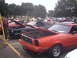 1978 Ford Mustang II - Two Ford Mustang IIs, one red and one black, are displayed with their hoods open at an outdoor car show.