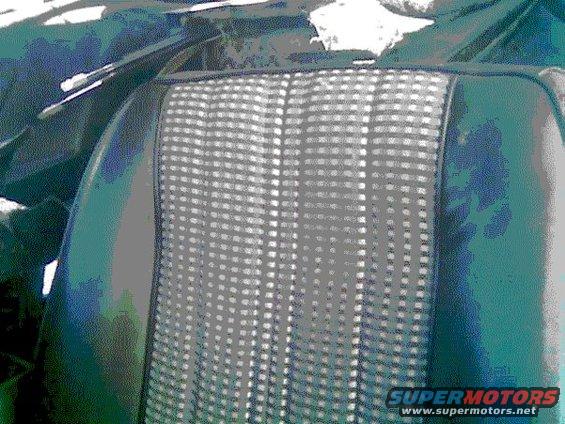 Close-up of car seat fabric with a checkered pattern and dark green vinyl bolsters. Supermotors logo visible