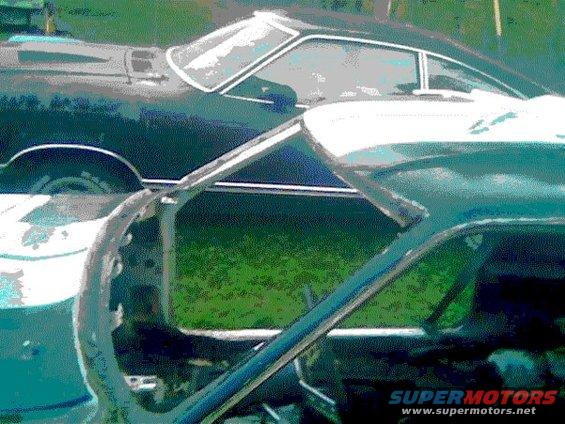 side view of two cars, one dark, one light blue, parked outside