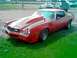1978 Ford Mustang II - This red 1978 Chevrolet Camaro Z/28 features a prominent hood scoop and racing stripes, viewed from the front three-quarter angle.
