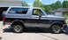 1995 Ford Bronco - This 1995 Ford Bronco features a two-tone paint scheme with gray on top and black on the lower half.