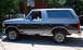 1995 Ford Bronco - This two-tone Ford Bronco is shown from the side, with a basketball hoop in the background.