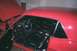 1967 Ford Mustang - Interior view of a red 1967 Ford Mustang, showing the black seats, dashboard, and steering wheel.