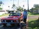 1967 Ford Mustang - A red 1967 Ford Mustang coupe is shown on a trailer, a distinctive hood scoop and dual headlights.