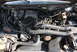 1995 Ford Bronco - The engine bay of a vehicle, a V8 engine, dual intake hoses, and visible alternator.