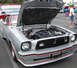1978 Ford Mustang II - Silver coupe from the 1970s with hood open, revealing the engine bay. Red pinstripes accent the bodywork.