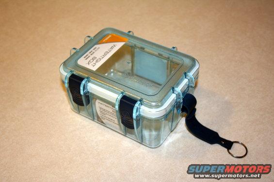 Clear plastic watertight box with blue latches and a black strap with a keyring