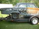 1964 Ford Fairlane - This 1964 Ford Fairlane is seen on a trailer, displaying significant bodywork and rust as part of its restoration process.