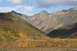 1990 Chevrolet Suburban - A scenic view of mountains and a valley filled with colorful autumn foliage under a partly cloudy sky.