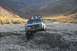 1990 Chevrolet Suburban - This pickup truck is navigating a rocky terrain in a mountainous area.