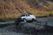 1990 Chevrolet Suburban - 1990 Chevrolet Suburban navigating a rough, rocky terrain during an off-road excursion.
